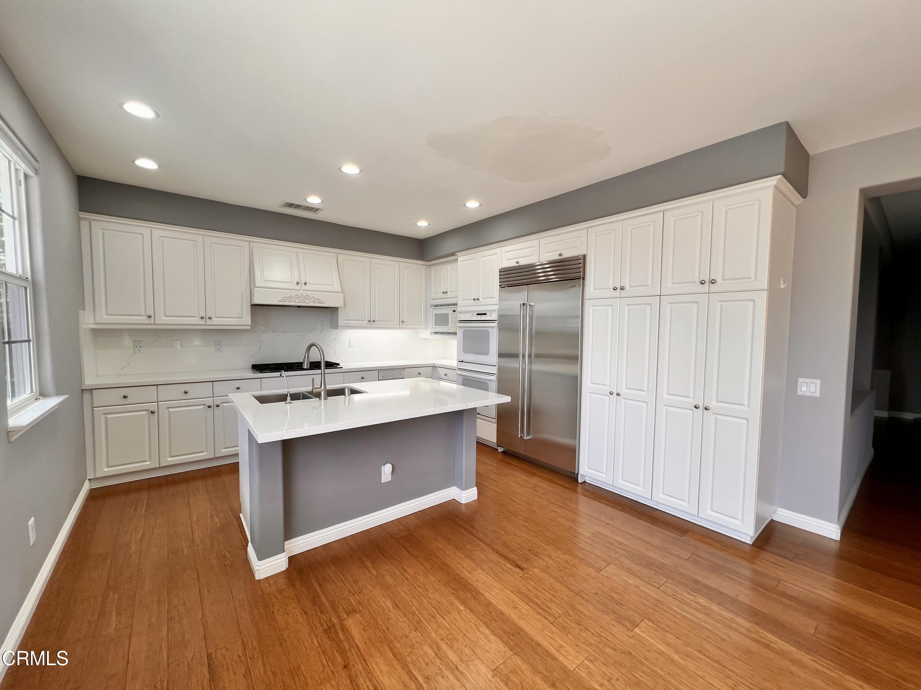 652 Corte Elegante Camarillo, CA 93010 - Photo 4 of 18 a kitchen with stainless steel appliances granite countertop a stove a sink and a refrigerator