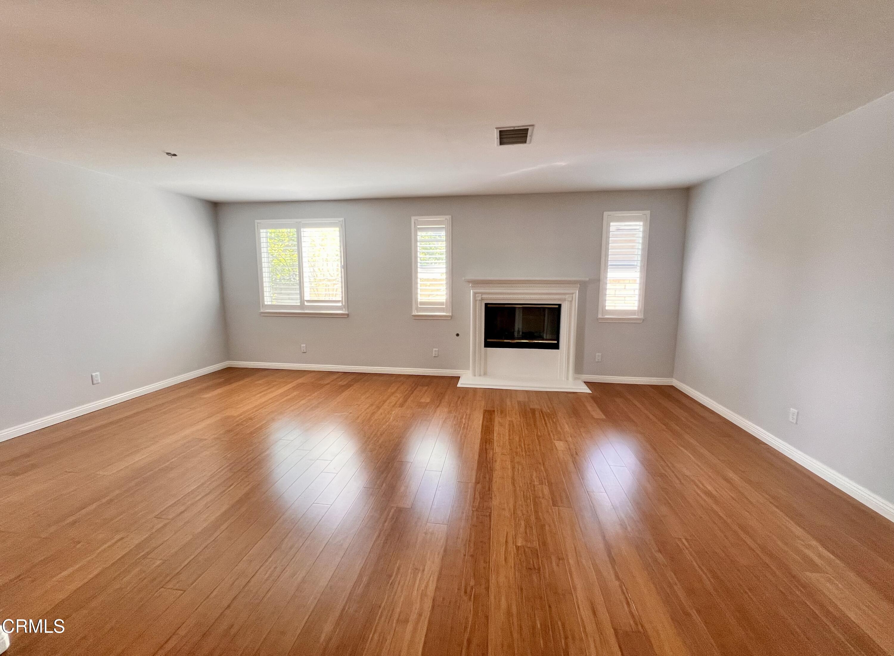 652 Corte Elegante Camarillo, CA 93010 - Photo 6 of 18 a view of empty room with wooden floor and fireplace