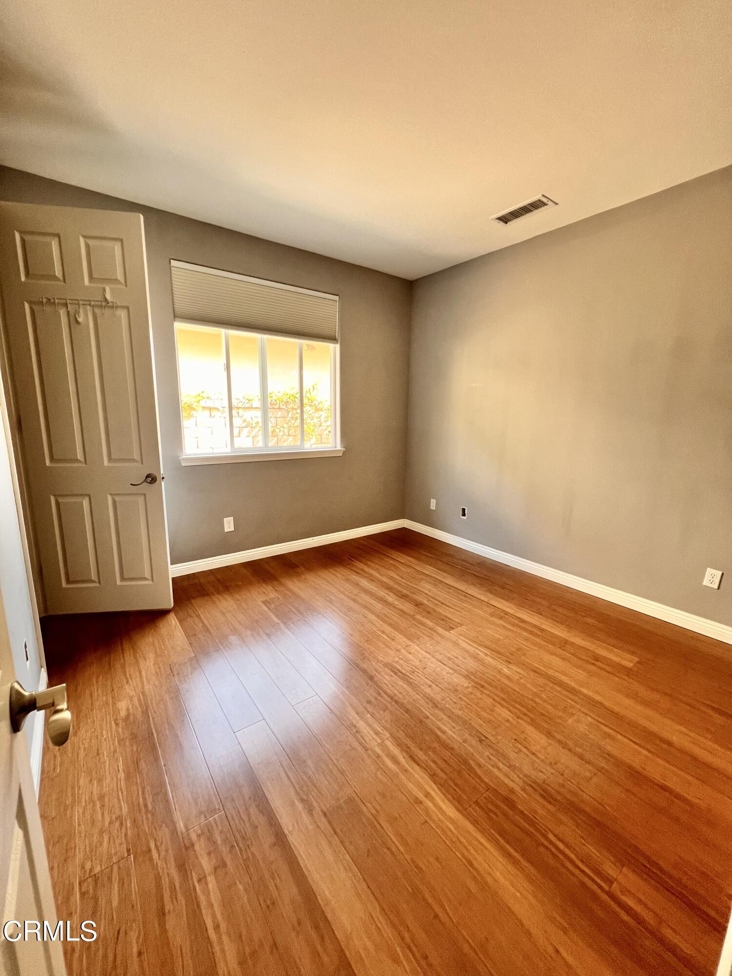 652 Corte Elegante Camarillo, CA 93010 - Photo 8 of 18 an empty room with wooden floor and windows