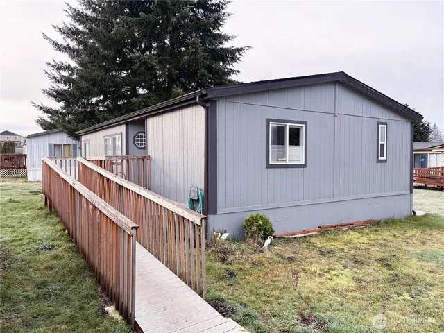 a view of a house with wooden fence