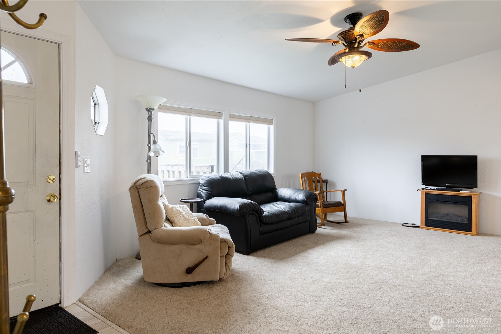8915 Wilkensen Road Southeast, Unit 9B Yelm, WA 98597 - Photo 11 of 37 a living room with furniture and a flat screen tv
