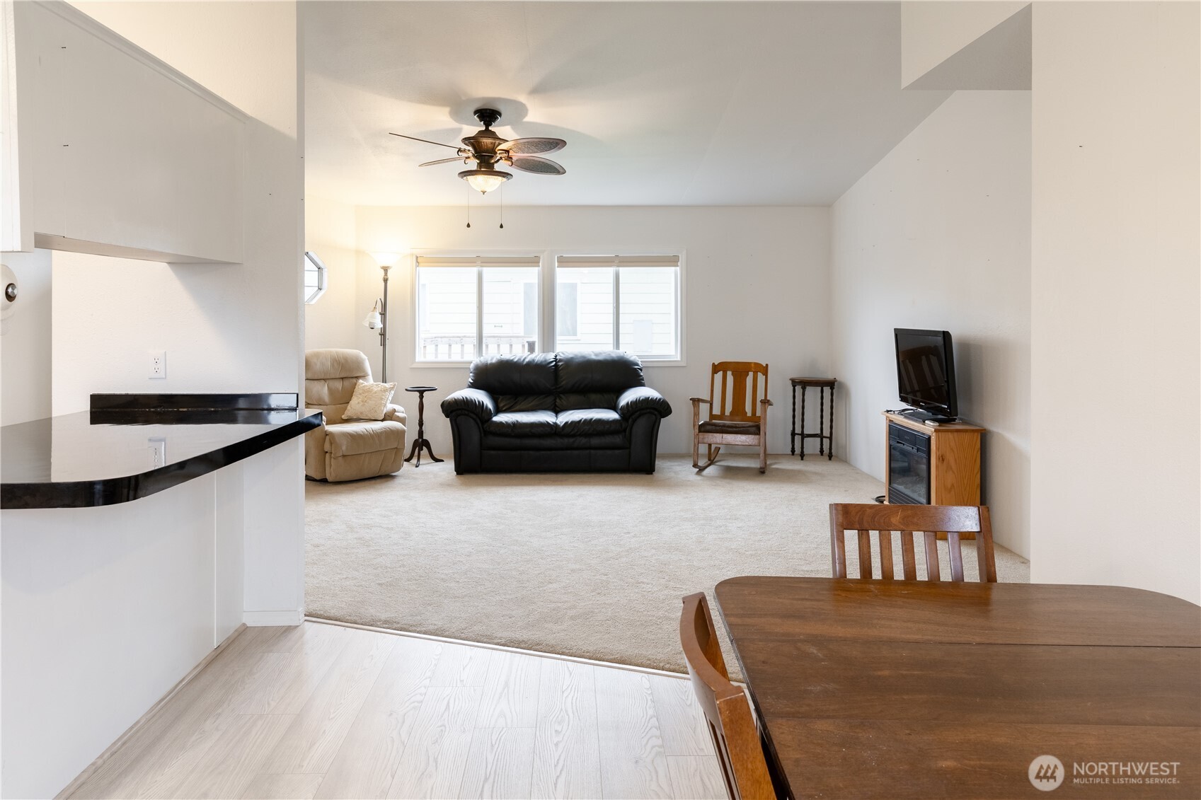 8915 Wilkensen Road Southeast, Unit 9B Yelm, WA 98597 - Photo 13 of 37 a living room with furniture and a flat screen tv