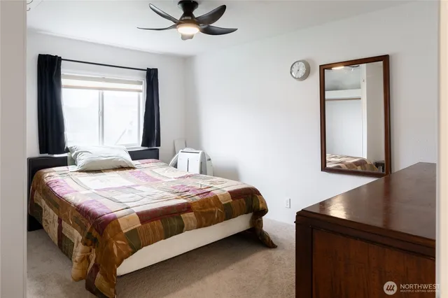 a bedroom with a bed and a window