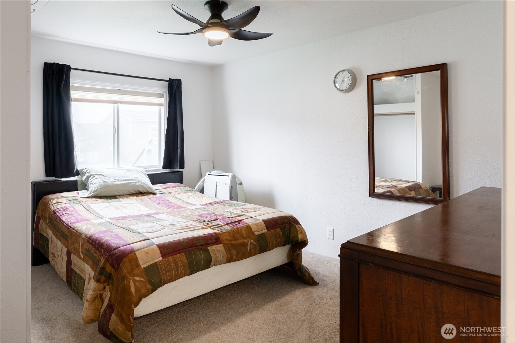 8915 Wilkensen Road Southeast, Unit 9B Yelm, WA 98597 - Photo 20 of 37 a bedroom with a bed and a window