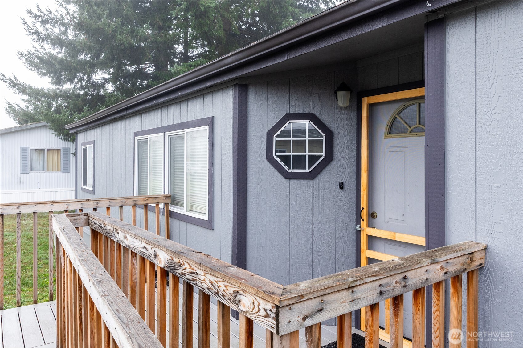 8915 Wilkensen Road Southeast, Unit 9B Yelm, WA 98597 - Photo 2 of 37 a view of a balcony with furniture and wooden floor