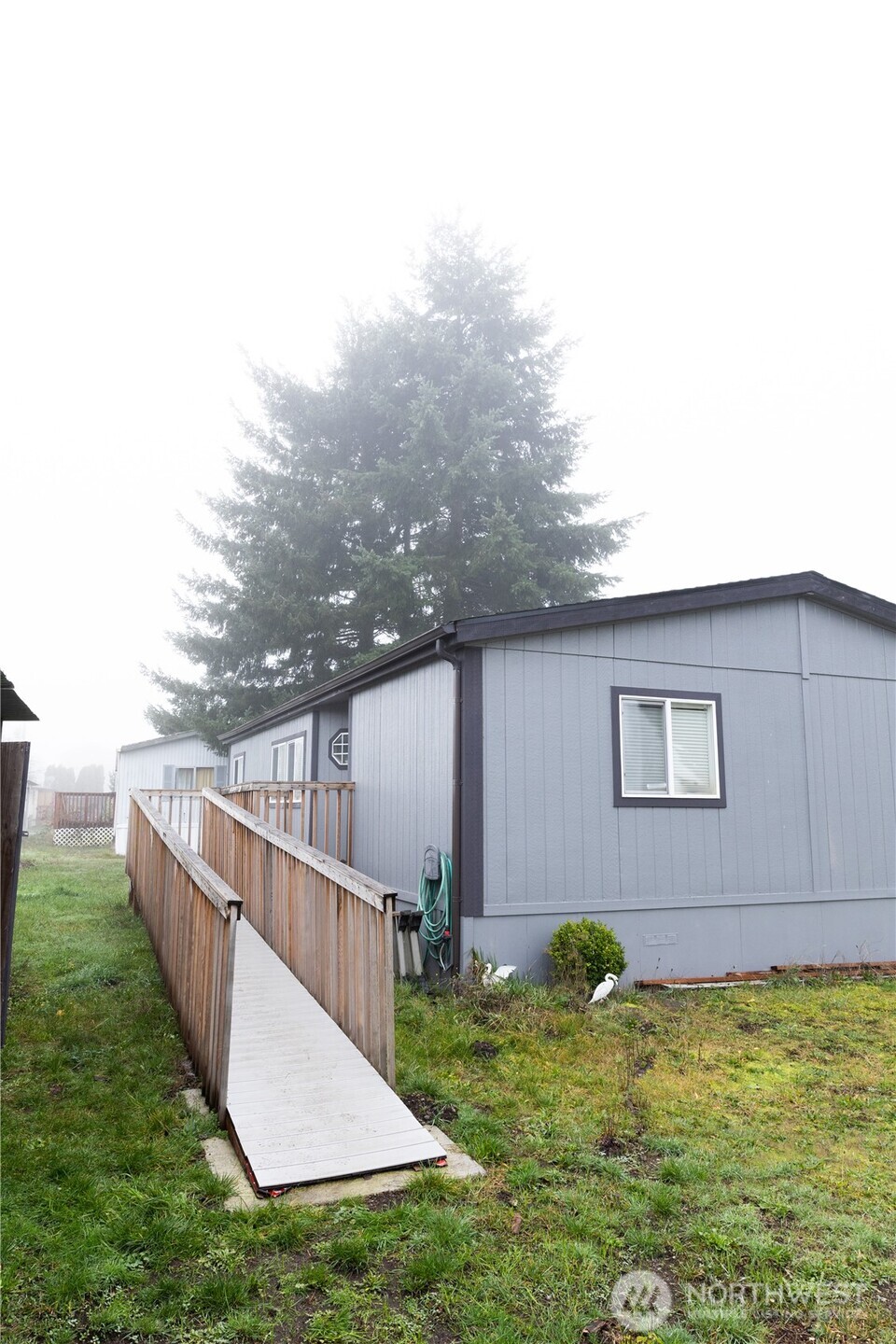 8915 Wilkensen Road Southeast, Unit 9B Yelm, WA 98597 - Photo 28 of 37 a view of a house with a yard
