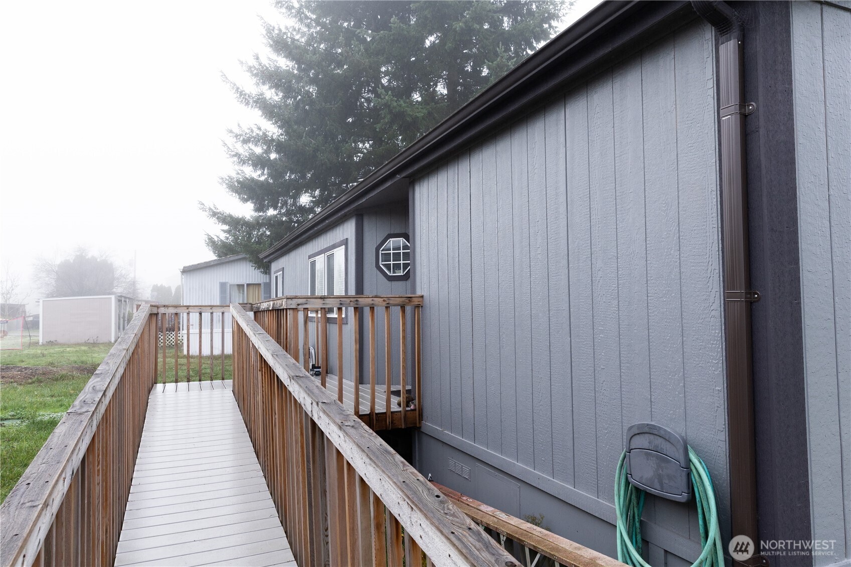 8915 Wilkensen Road Southeast, Unit 9B Yelm, WA 98597 - Photo 30 of 37 a view of balcony with wooden floor and fence