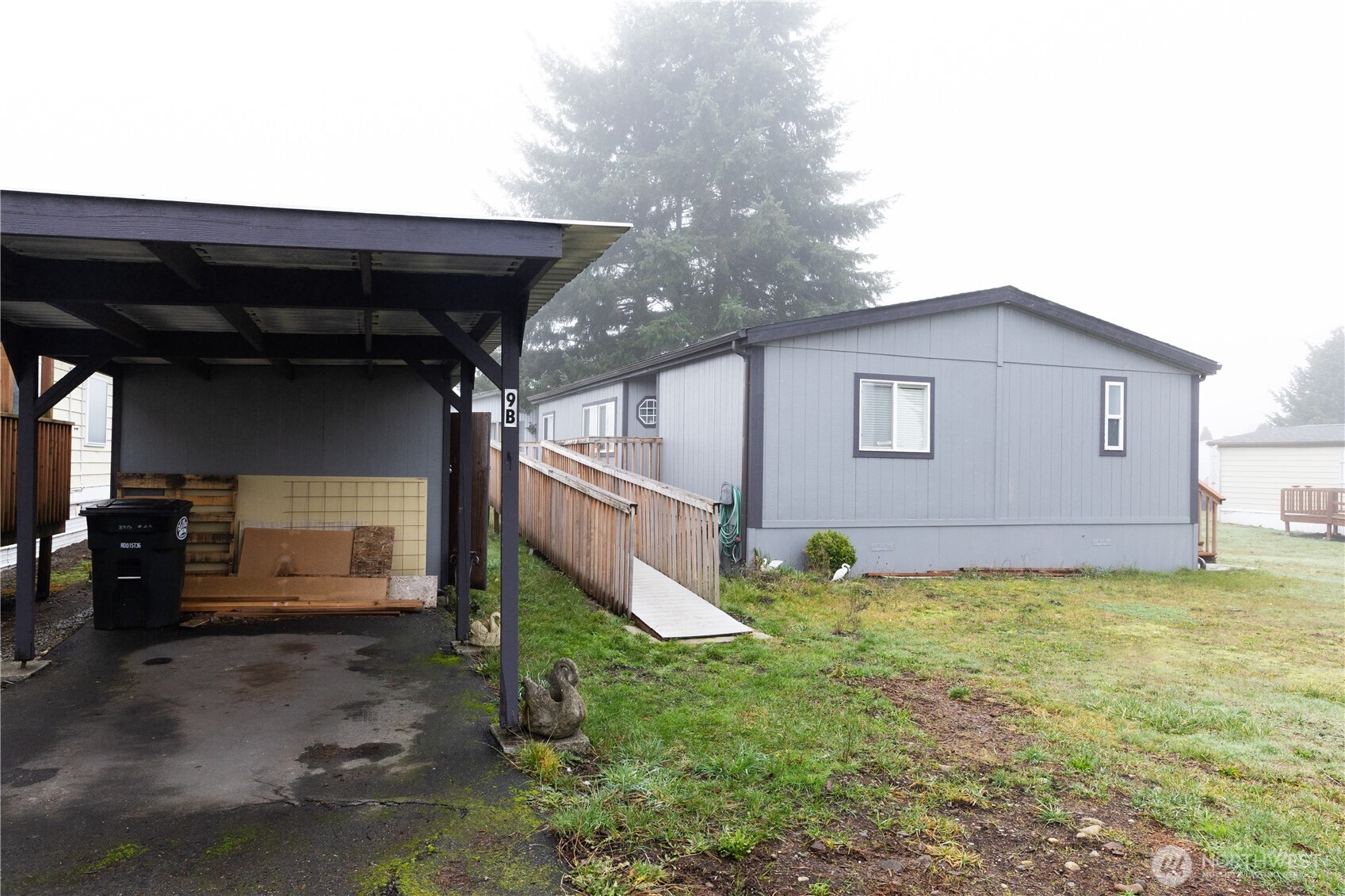 8915 Wilkensen Road Southeast, Unit 9B Yelm, WA 98597 - Photo 34 of 37 a view of a house with backyard and sitting area