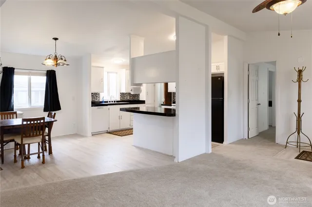 a kitchen with stainless steel appliances kitchen island granite countertop a refrigerator and a stove top oven