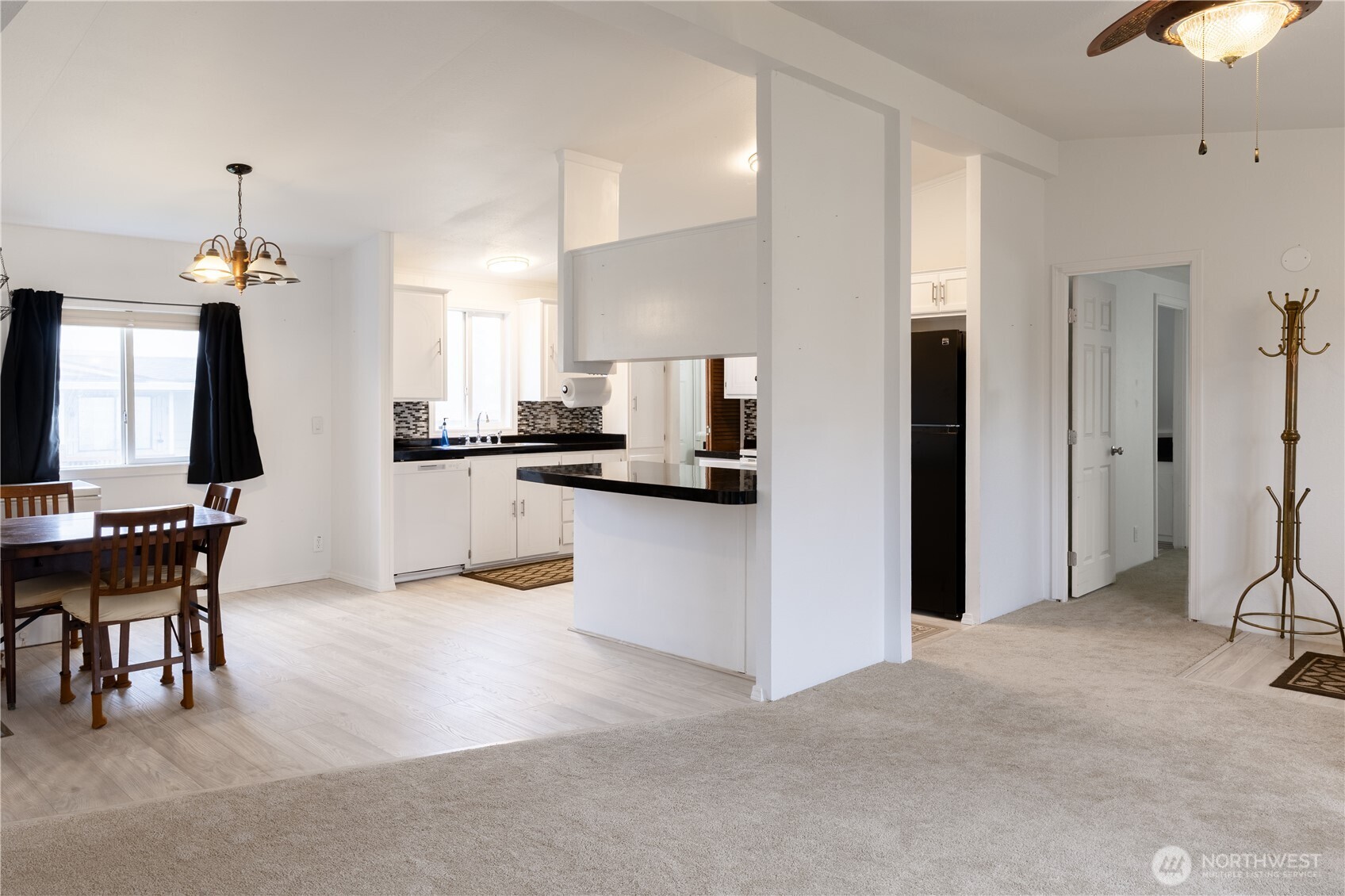 8915 Wilkensen Road Southeast, Unit 9B Yelm, WA 98597 - Photo 5 of 37 a kitchen with stainless steel appliances kitchen island granite countertop a refrigerator and a stove top oven