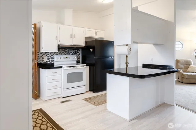 a kitchen with a stove and a refrigerator