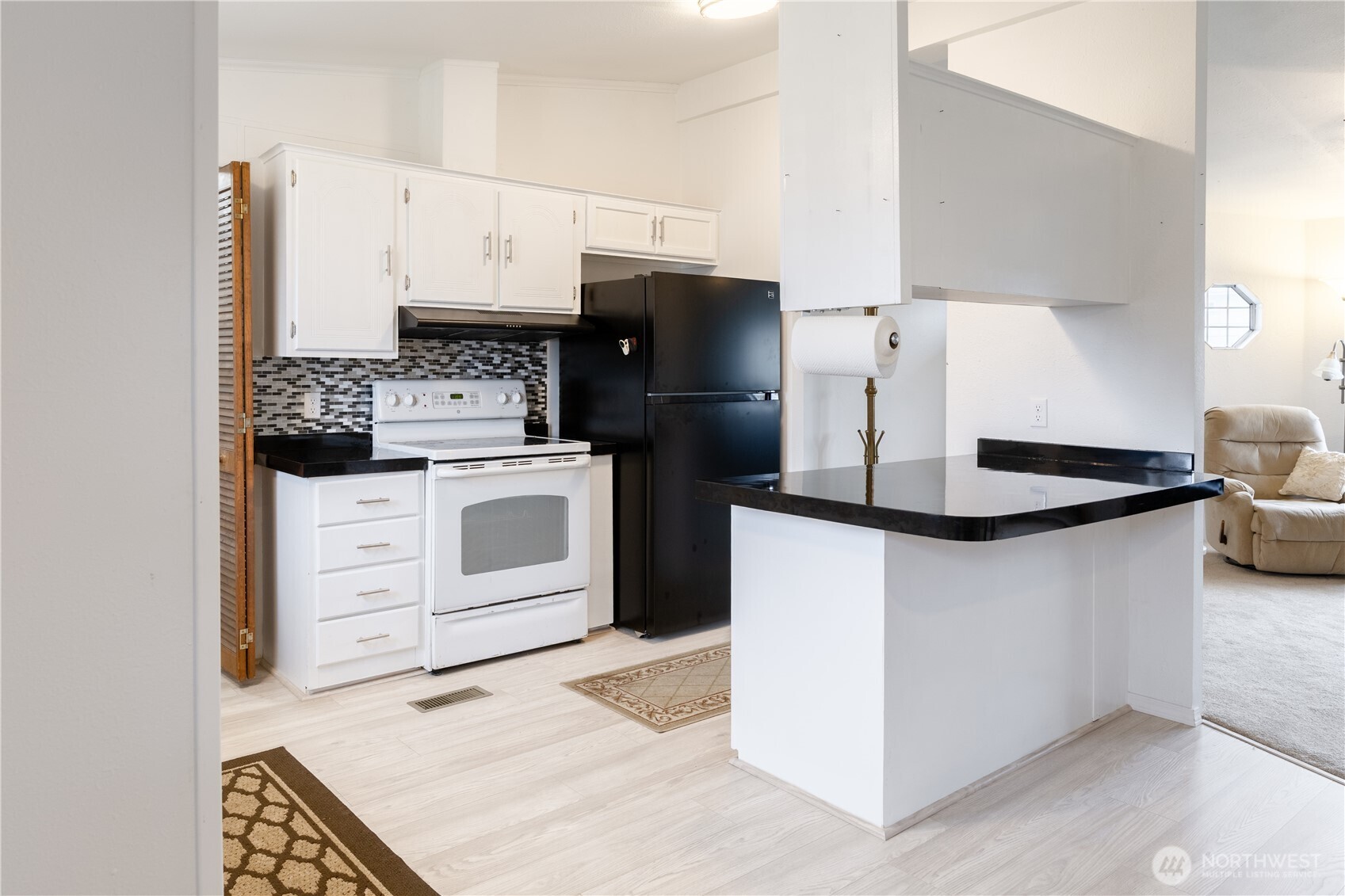 8915 Wilkensen Road Southeast, Unit 9B Yelm, WA 98597 - Photo 7 of 37 a kitchen with a stove and a refrigerator