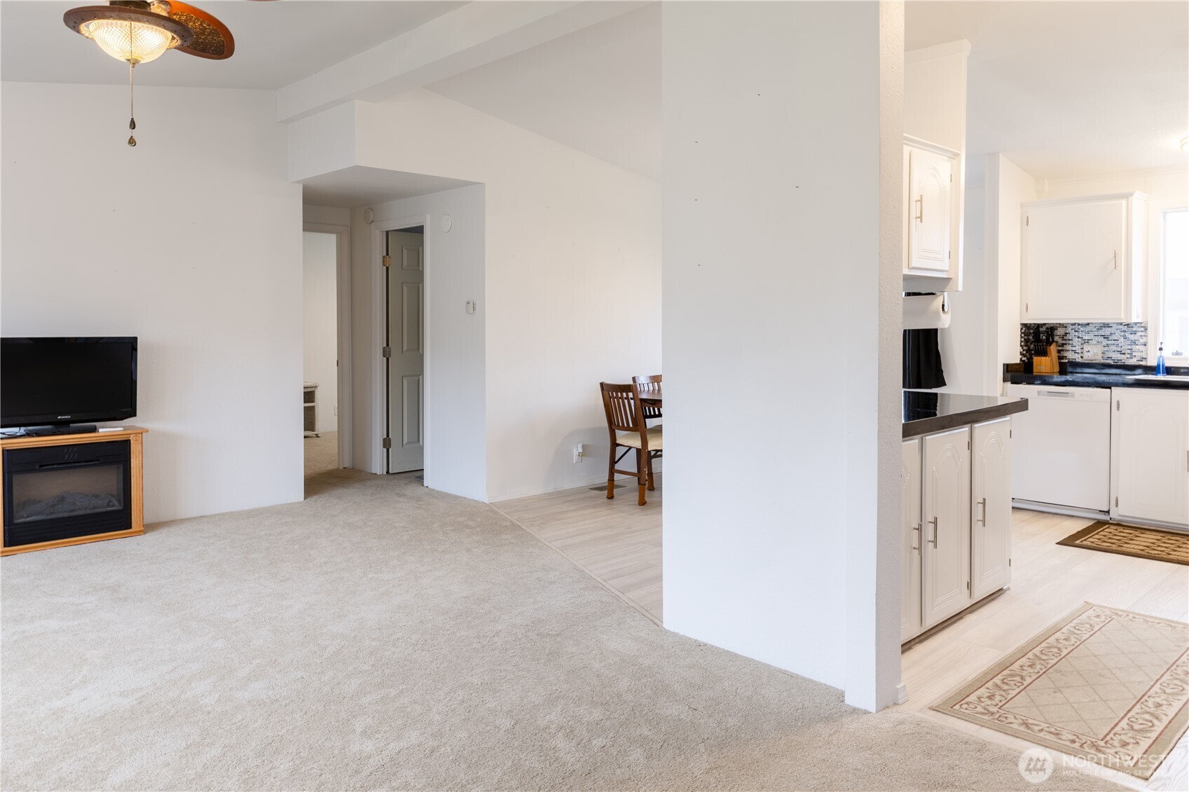 8915 Wilkensen Road Southeast, Unit 9B Yelm, WA 98597 - Photo 9 of 37 a view of a livingroom with furniture and an empty room