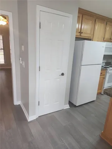 a view of an empty room and wooden floor