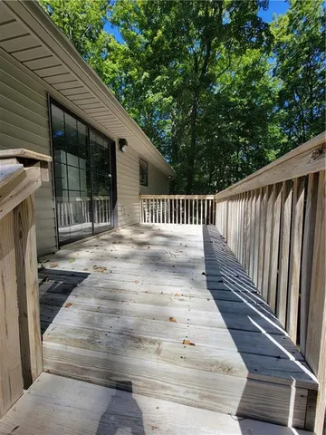 a view of deck with wooden floor and fence