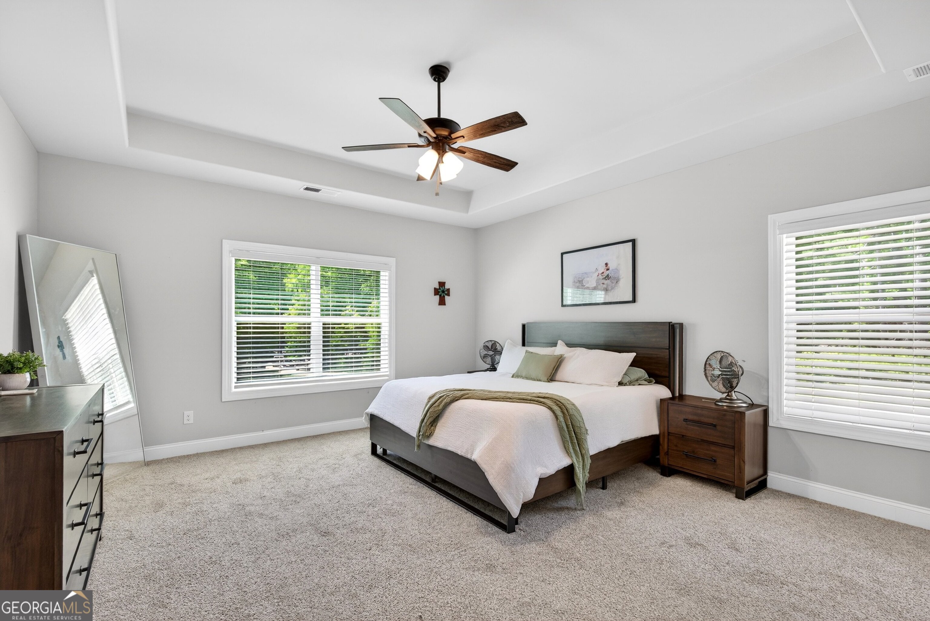 1764 Luther Bailey Road Senoia, GA 30276 - Photo 4 of 63 a spacious bedroom with a bed a chandelier and a window