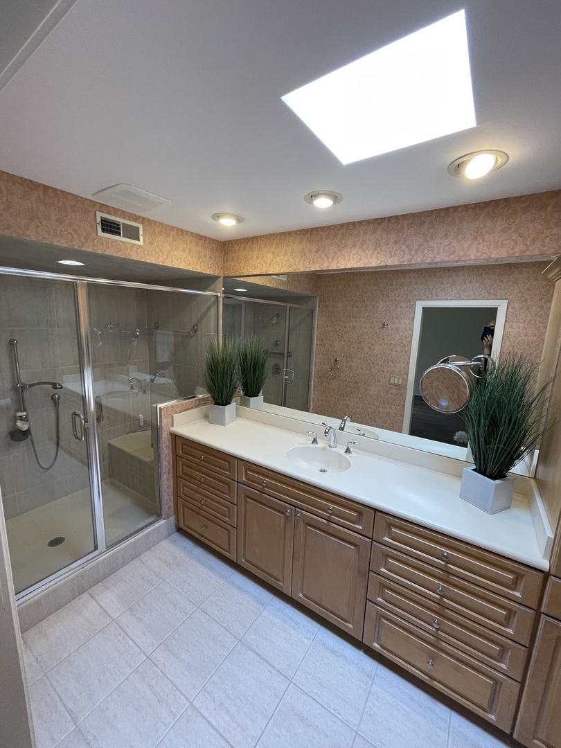 1119 Deerfield Road Deerfield, IL 60015 - Photo 20 of 30 a bathroom with a double vanity sink a large mirror and shower