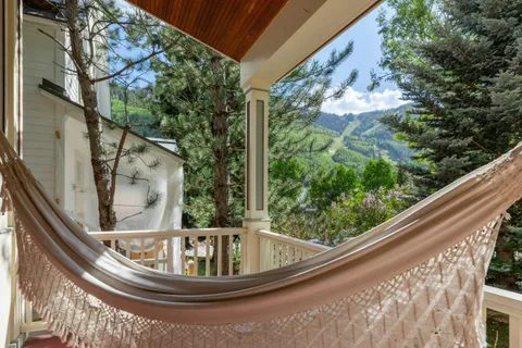 a view of a chairs and table in the balcony