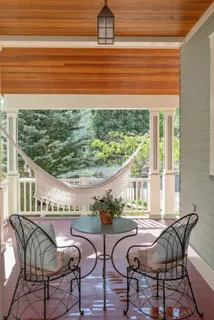 a view of a chair and table in front of house