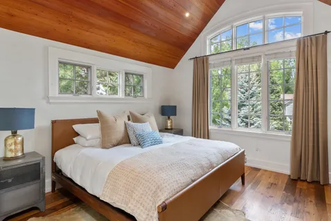 a bedroom with a bed and a lamp on table