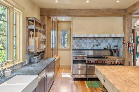 a kitchen with stainless steel appliances granite countertop a stove and a sink