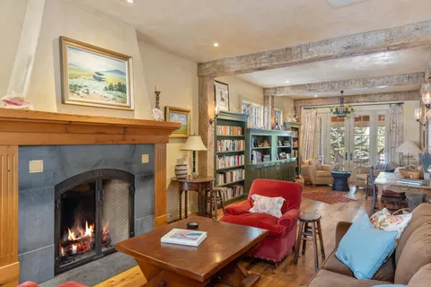 a living room with furniture lots of books and a book shelf