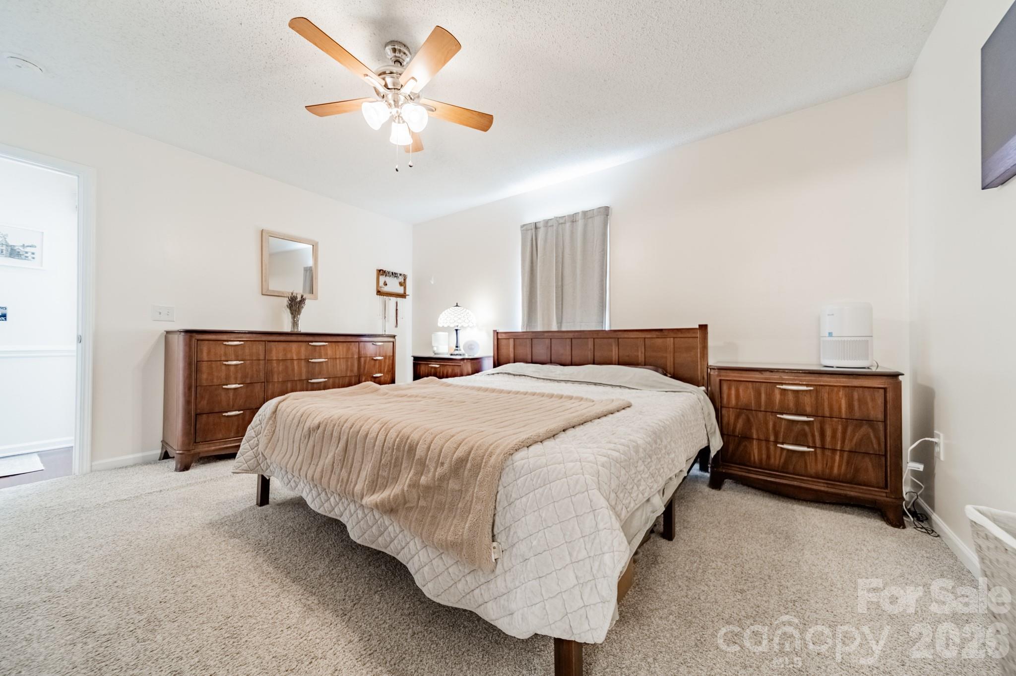 1015 South Walnut Street Kannapolis, NC 28081 - Photo 11 of 19 a bedroom with a bed and a chandelier