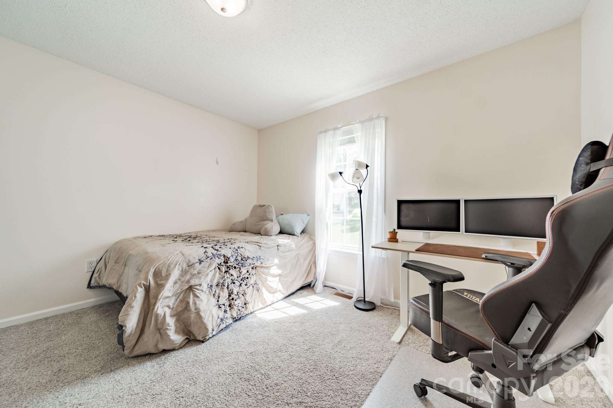 1015 South Walnut Street Kannapolis, NC 28081 - Photo 14 of 19 a bedroom with a bed and a chair