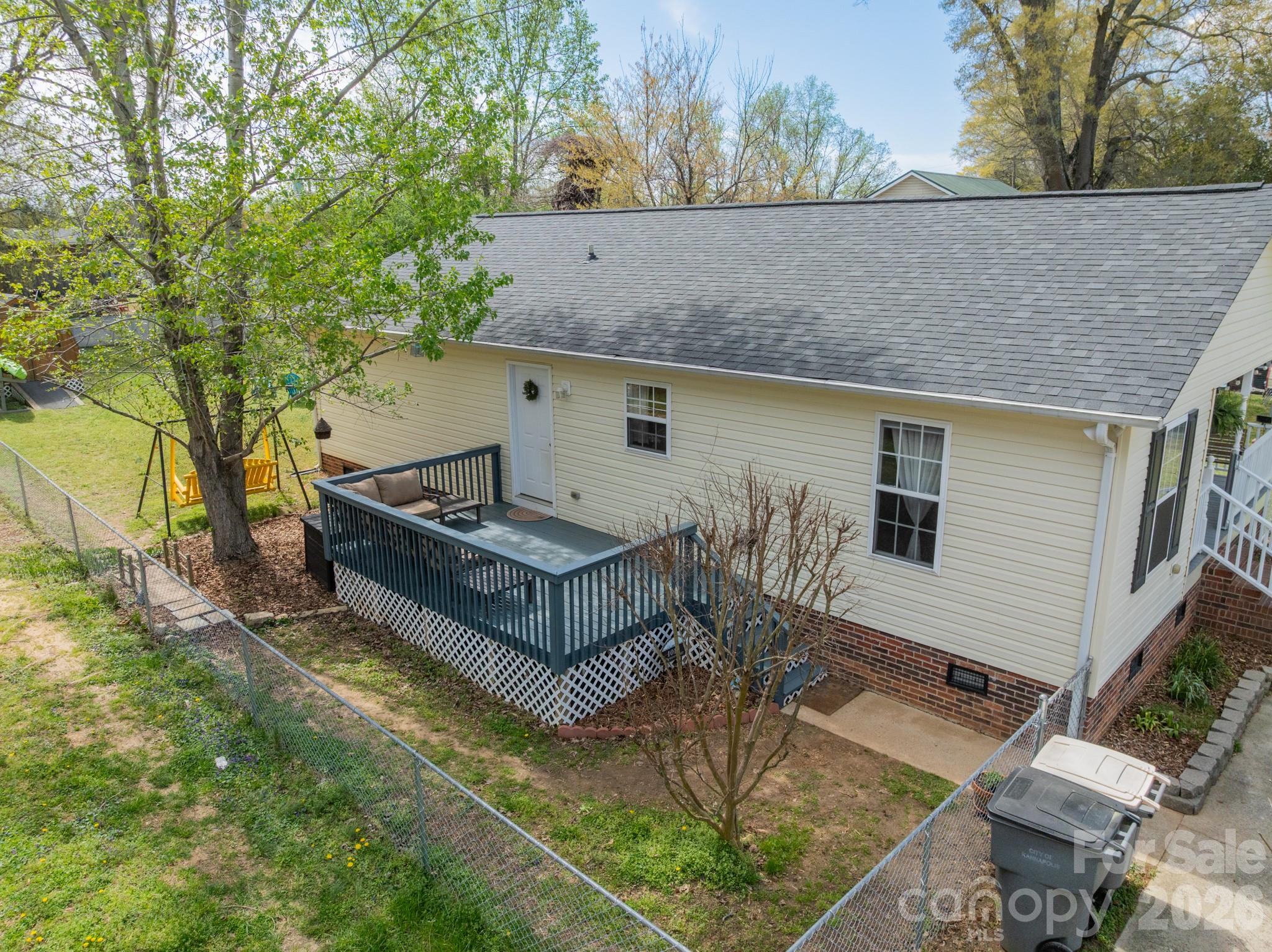 1015 South Walnut Street Kannapolis, NC 28081 - Photo 17 of 19 a backyard of a house with large trees and outdoor seating