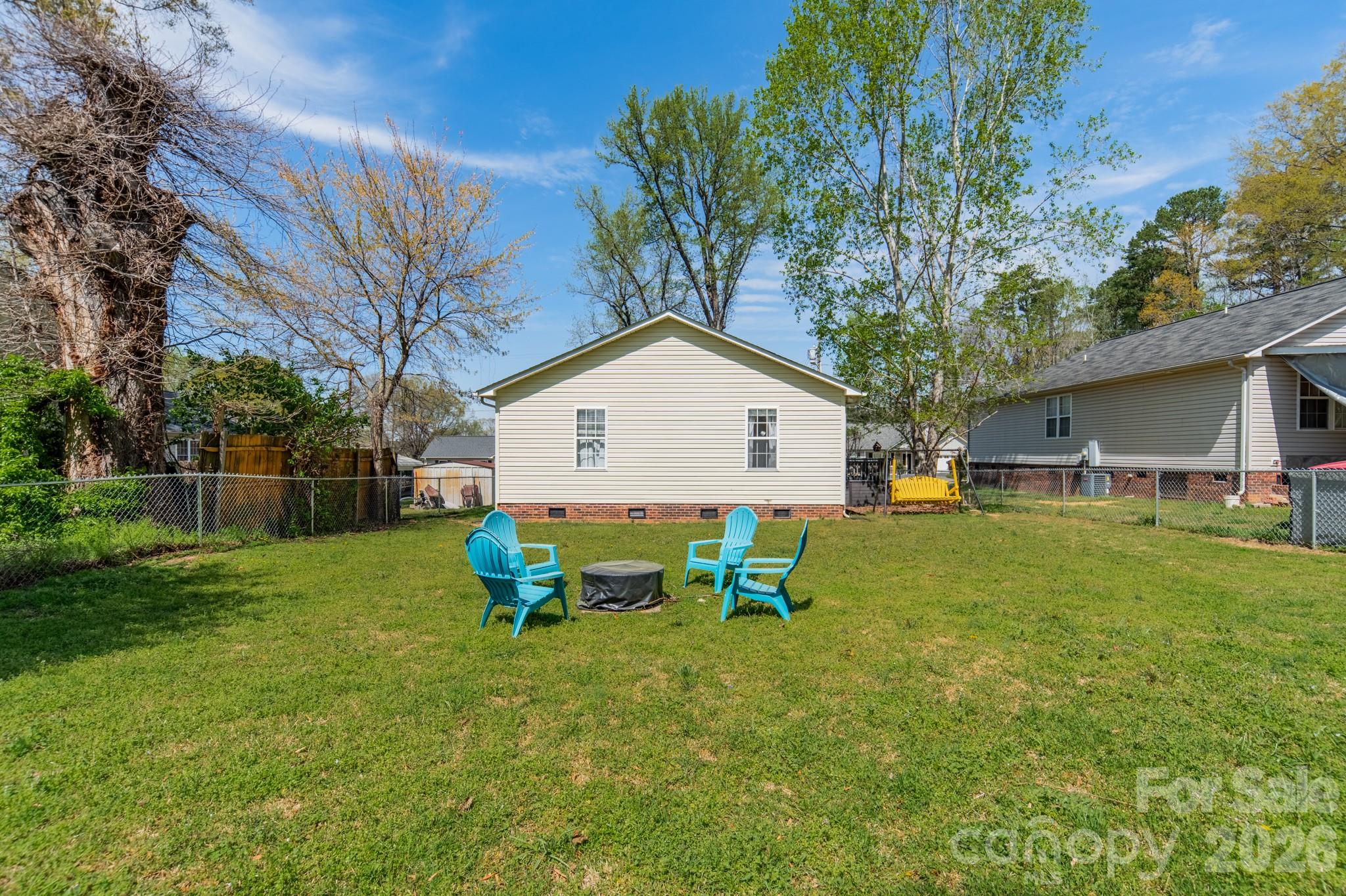 1015 South Walnut Street Kannapolis, NC 28081 - Photo 18 of 19 a view of backyard of house with wooden fence and large trees