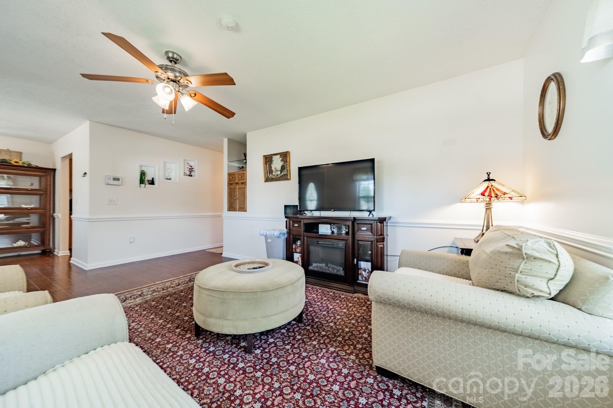 1015 South Walnut Street Kannapolis, NC 28081 - Photo 5 of 19 a living room with furniture a flat screen tv and a window