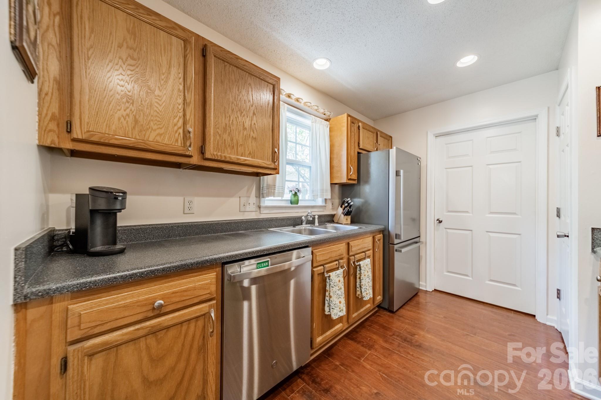 1015 South Walnut Street Kannapolis, NC 28081 - Photo 8 of 19 a kitchen with stainless steel appliances granite countertop a sink stove and cabinets