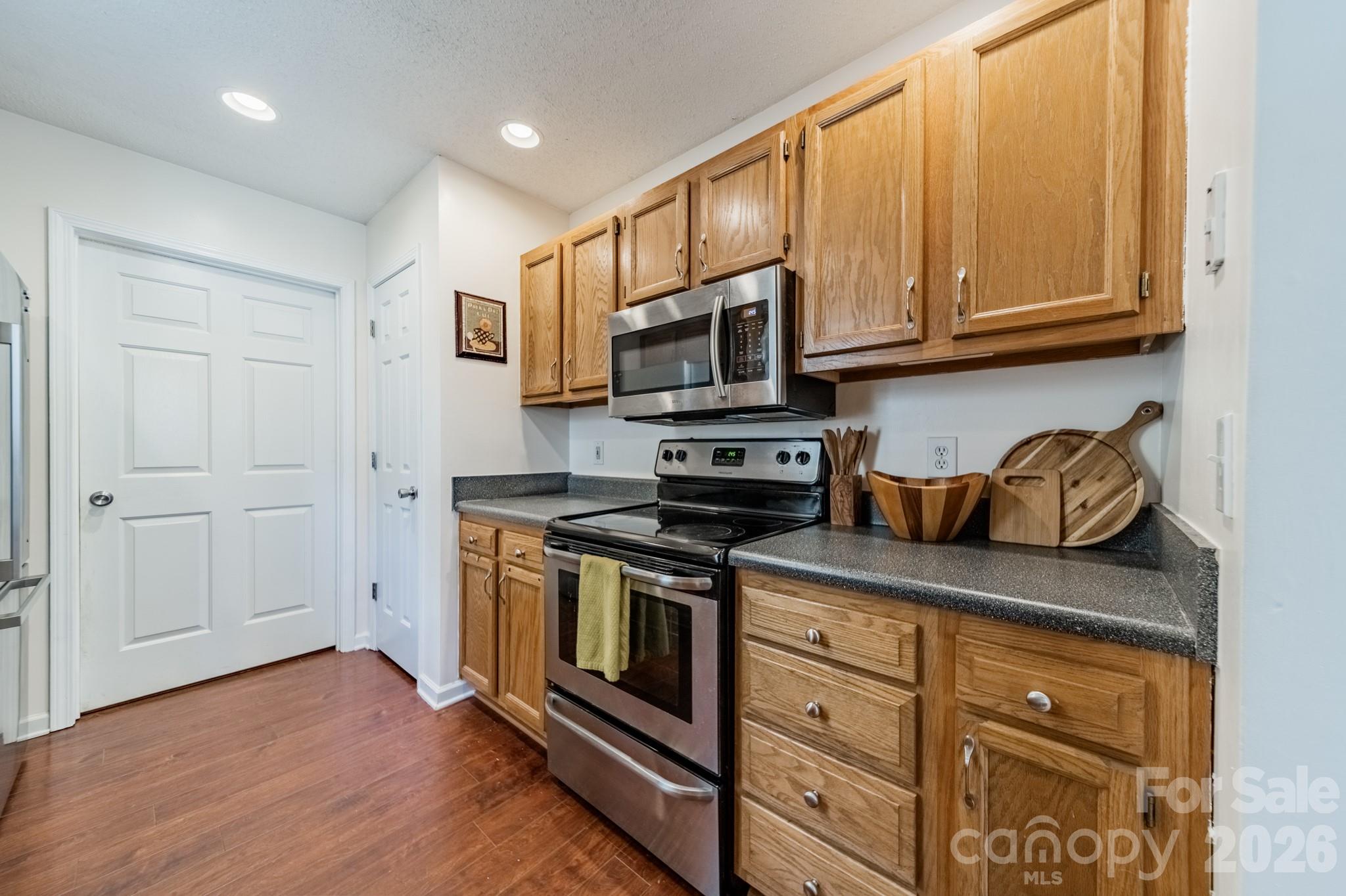 1015 South Walnut Street Kannapolis, NC 28081 - Photo 9 of 19 a kitchen with stainless steel appliances granite countertop a stove a sink and a microwave