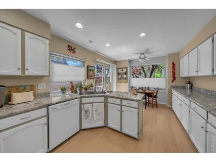 a kitchen with sink a stove and cabinets