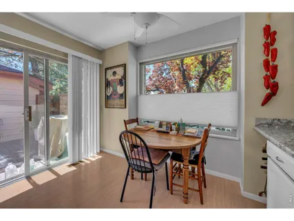 a view of a dining room with furniture large window and outside view