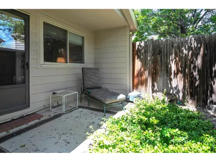 a backyard of a house with table and chairs