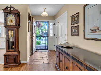 a view of a hallway to a livingroom with furniture