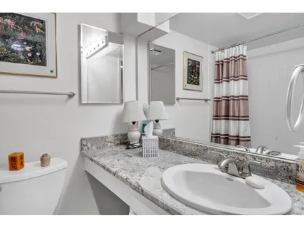 a bathroom with a granite countertop sink a mirror and a