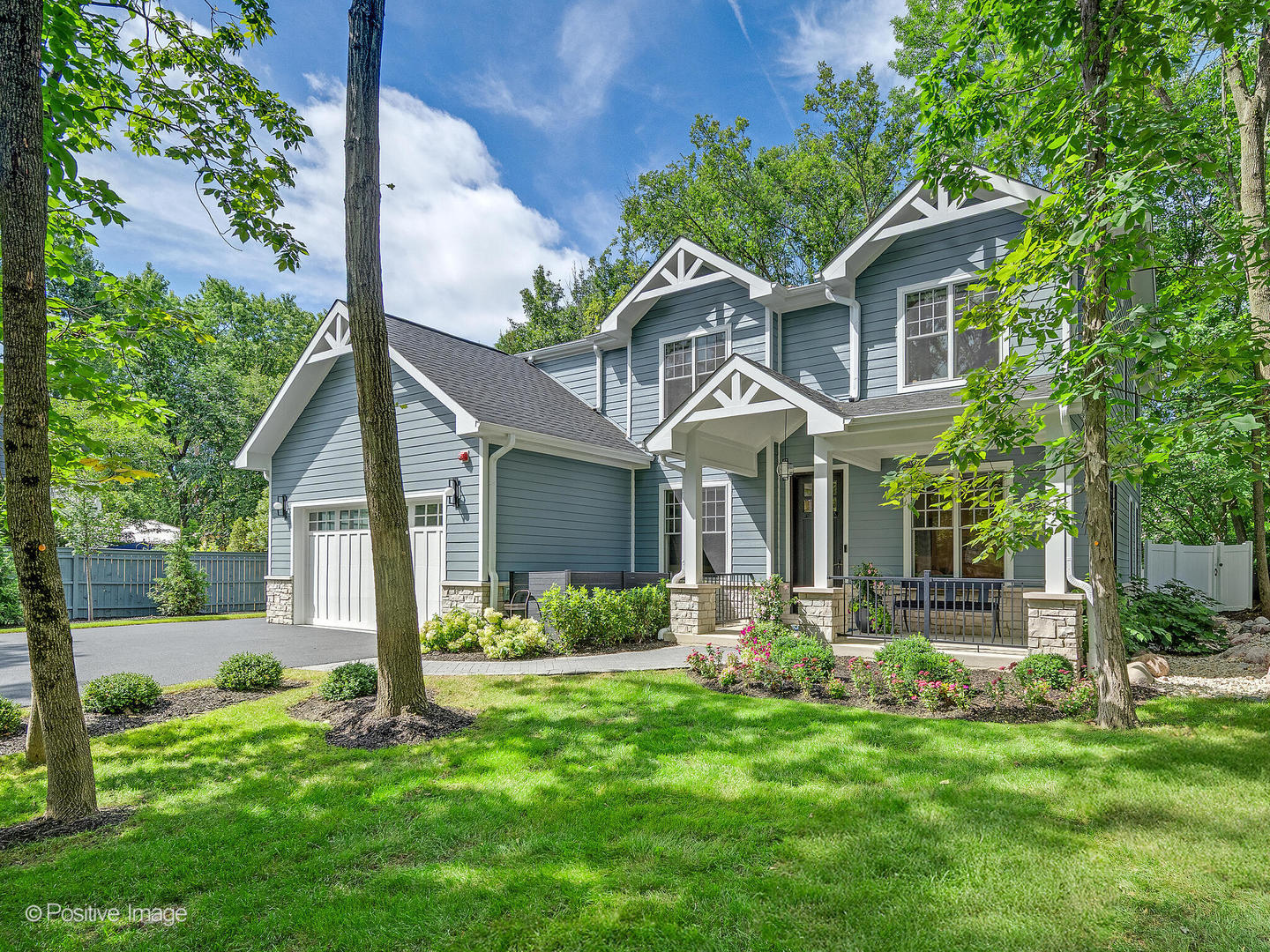 a front view of a house with a yard and porch