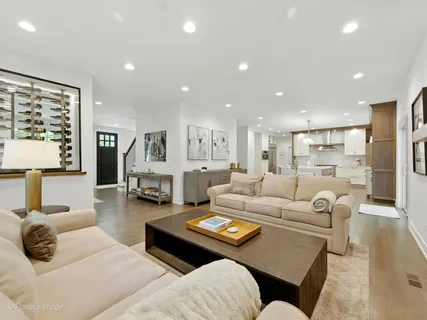a kitchen with a dining table chairs and wooden floor