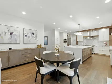 a dining room with furniture and wooden floor