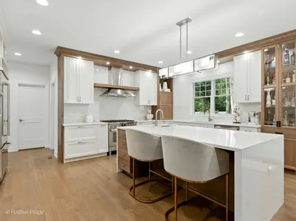 a kitchen with kitchen island a sink stove and refrigerator