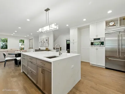 a kitchen with a stove a sink and a window