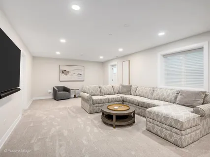 a view of a patio with couches chairs and wooden floor