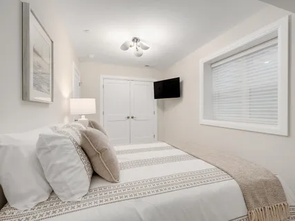 a view of a backyard with wooden fence and a large tree