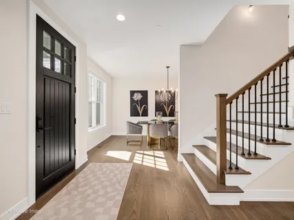a living room with furniture a piano and a flat screen tv