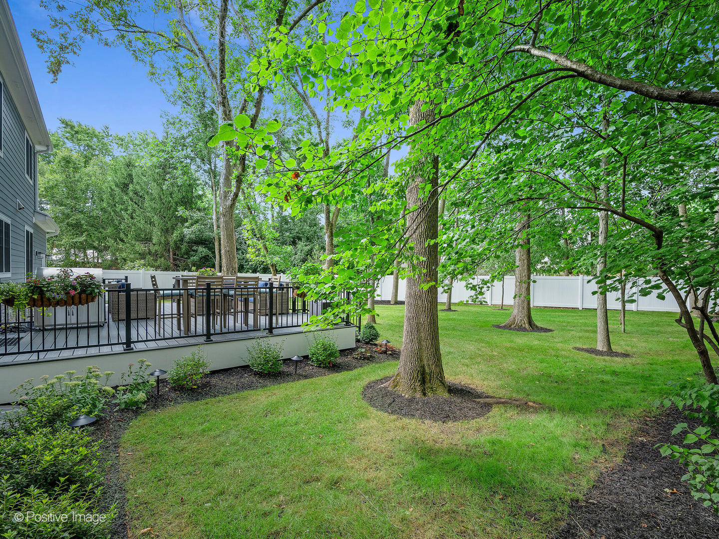 1150 Highland Avenue Lake Forest, IL 60045 - Photo 60 of 63 a view of a backyard with wooden fence and a large tree