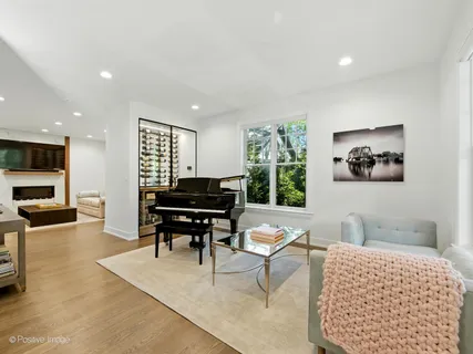 a view of a dining room with furniture a chandelier and wooden floor