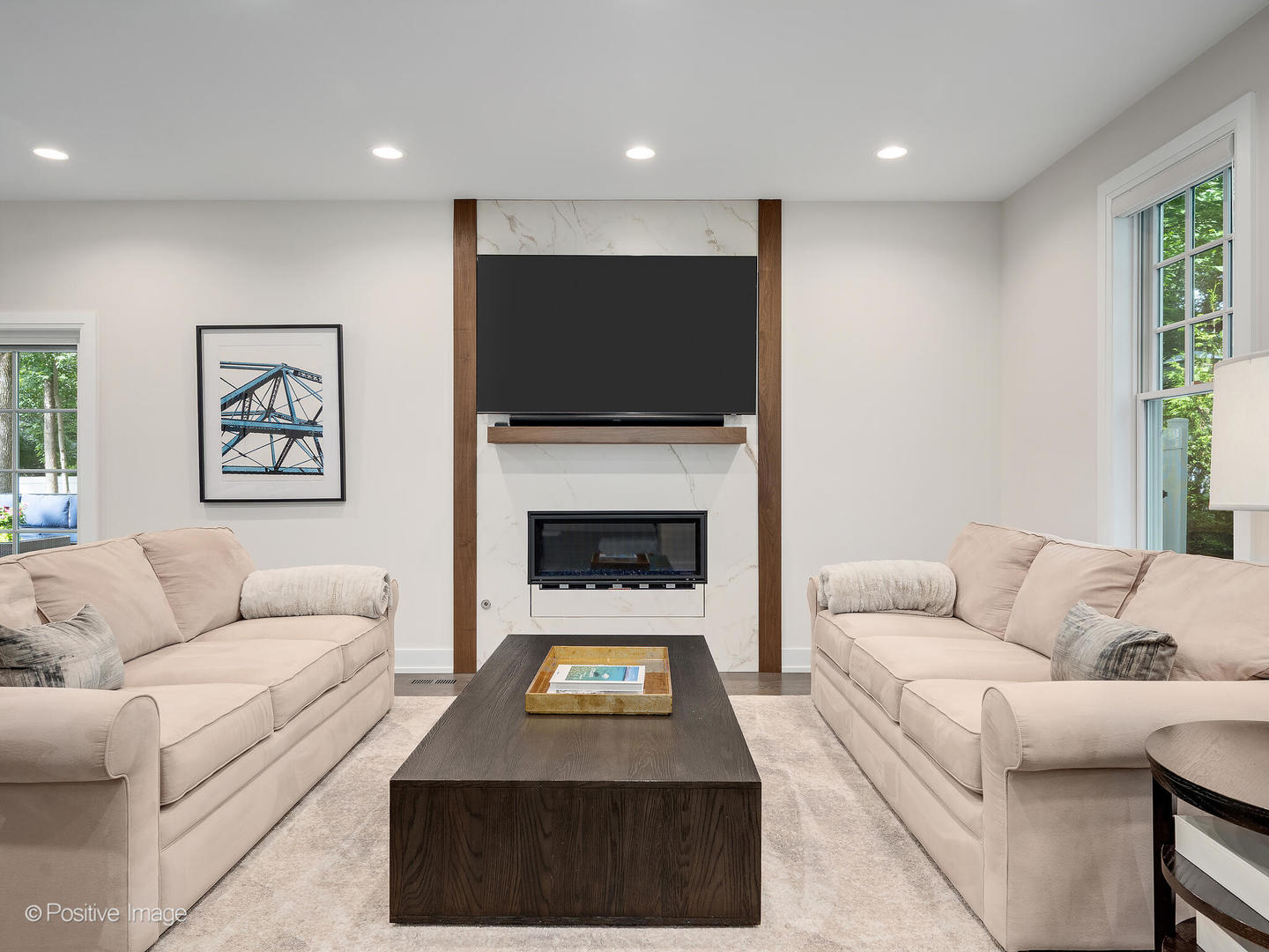 1150 Highland Avenue Lake Forest, IL 60045 - Photo 10 of 63 a living room with furniture a flat screen tv and a fireplace