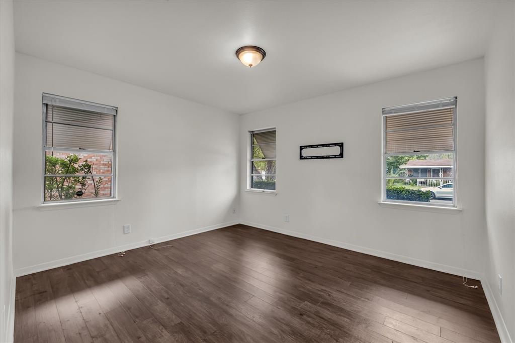 309 South Rita Street Lacy-Lakeview, TX 76705 - Photo 14 of 19 a view of an empty room with wooden floor and a window